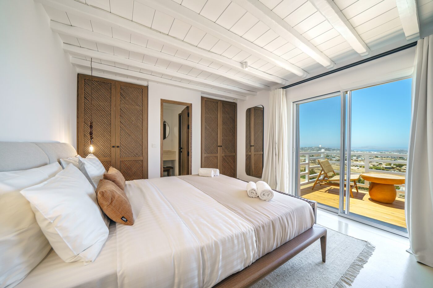 Villa Primadonna bedroom opening to the sea through full-height sliding doors
