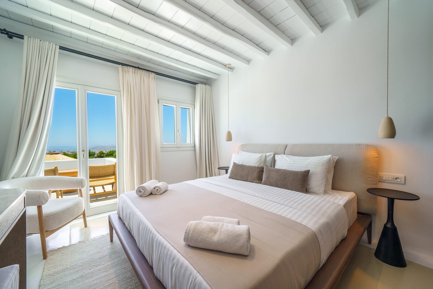 Twin bedroom opening onto a private sea-view terrace at Primadonna