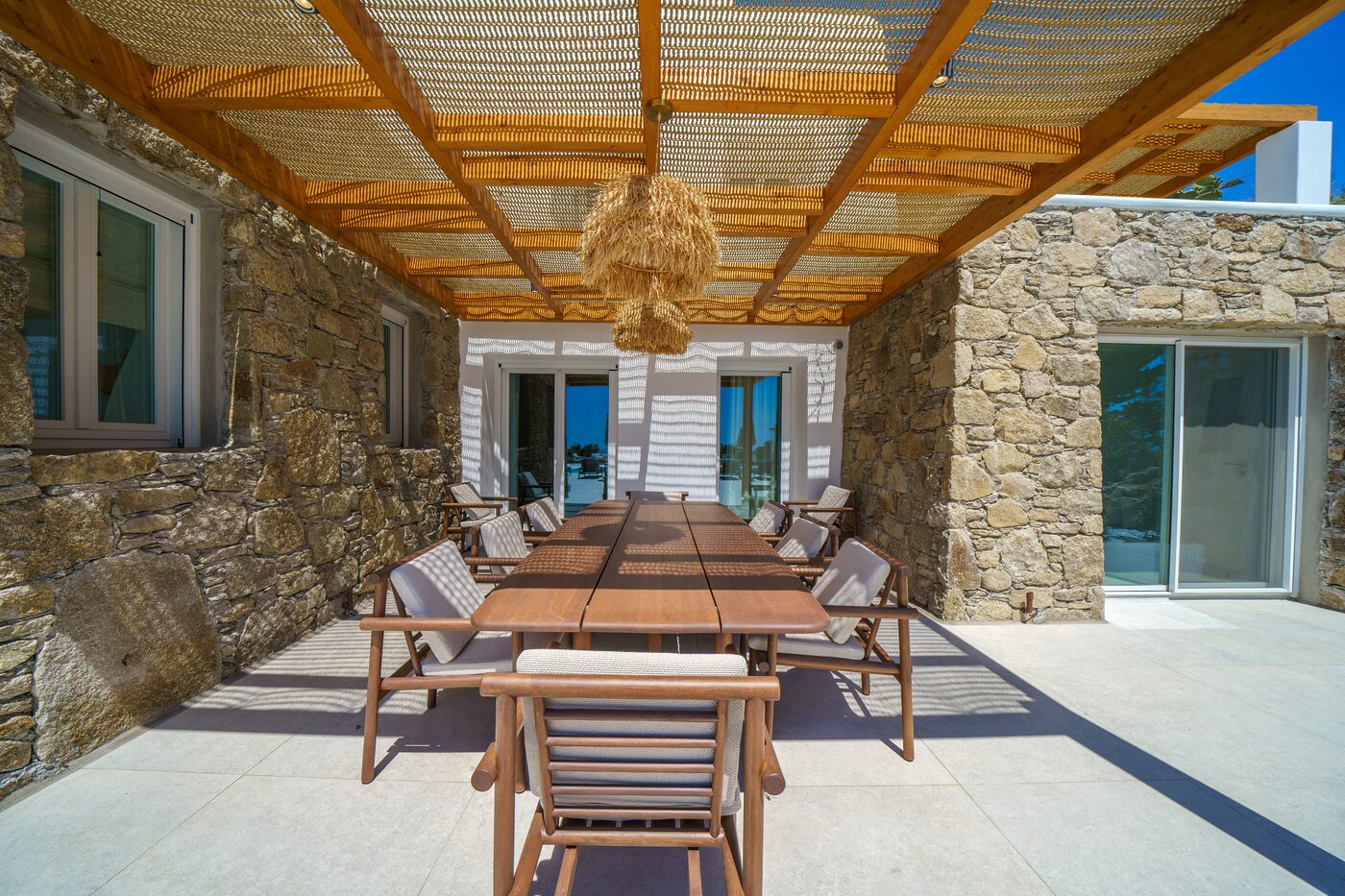 Shaded stone pergola and outdoor dining terrace