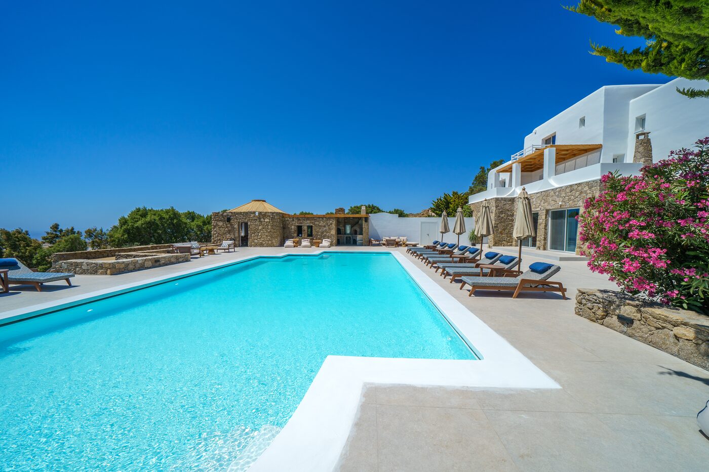 Poolside bougainvillea against whitewashed villa walls in Mykonos