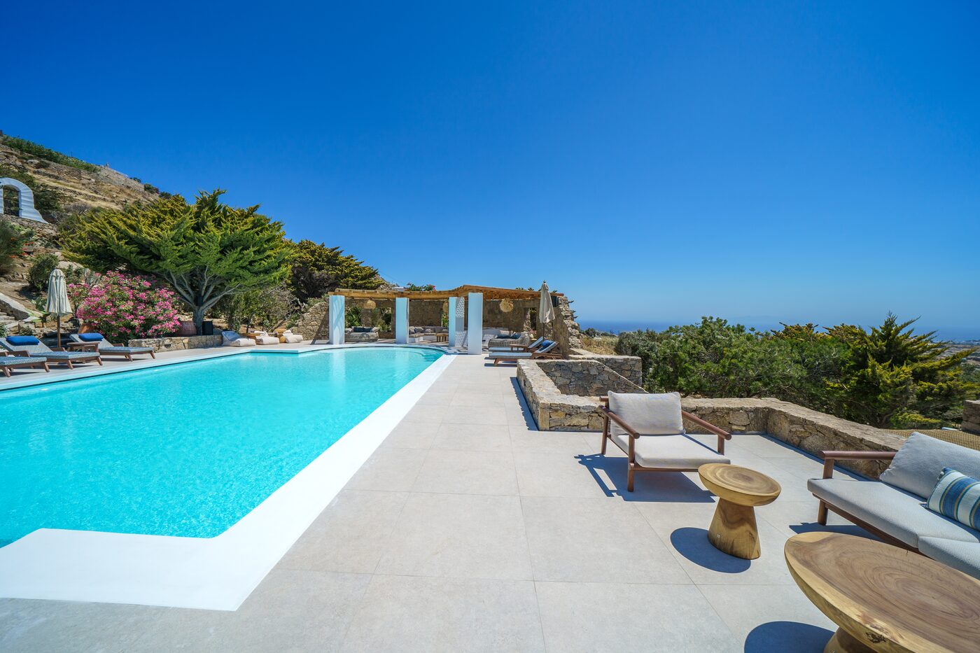 Infinity pool and stone-paved terrace overlooking the sea