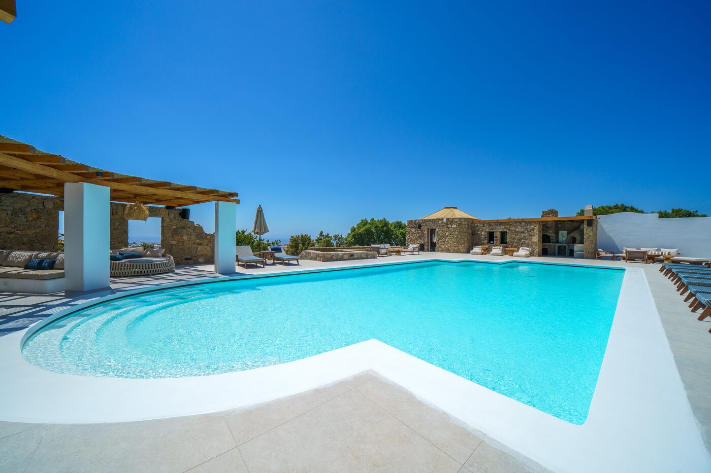 Estate pool and whitewashed villas on the Mykonian hillside