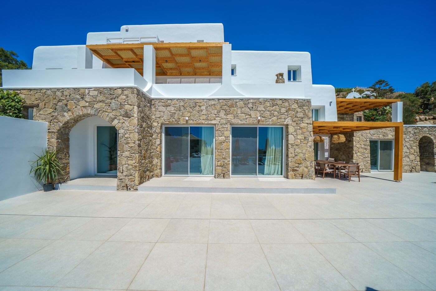 Natural stone and whitewashed Cycladic villa facade in Mykonos