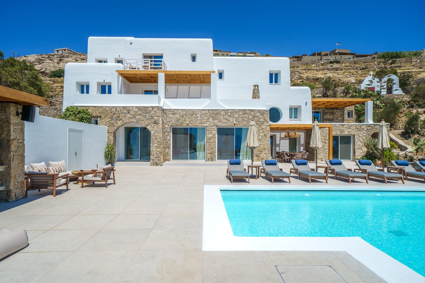 Villa facade and sun loungers on the pool deck, Mykonos