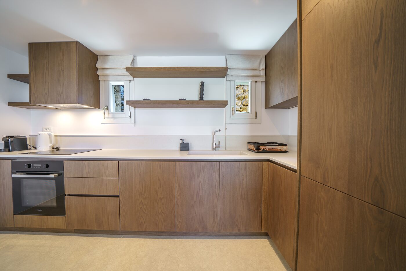 Fully equipped kitchen with oak cabinetry at Primadonna, Mykonos