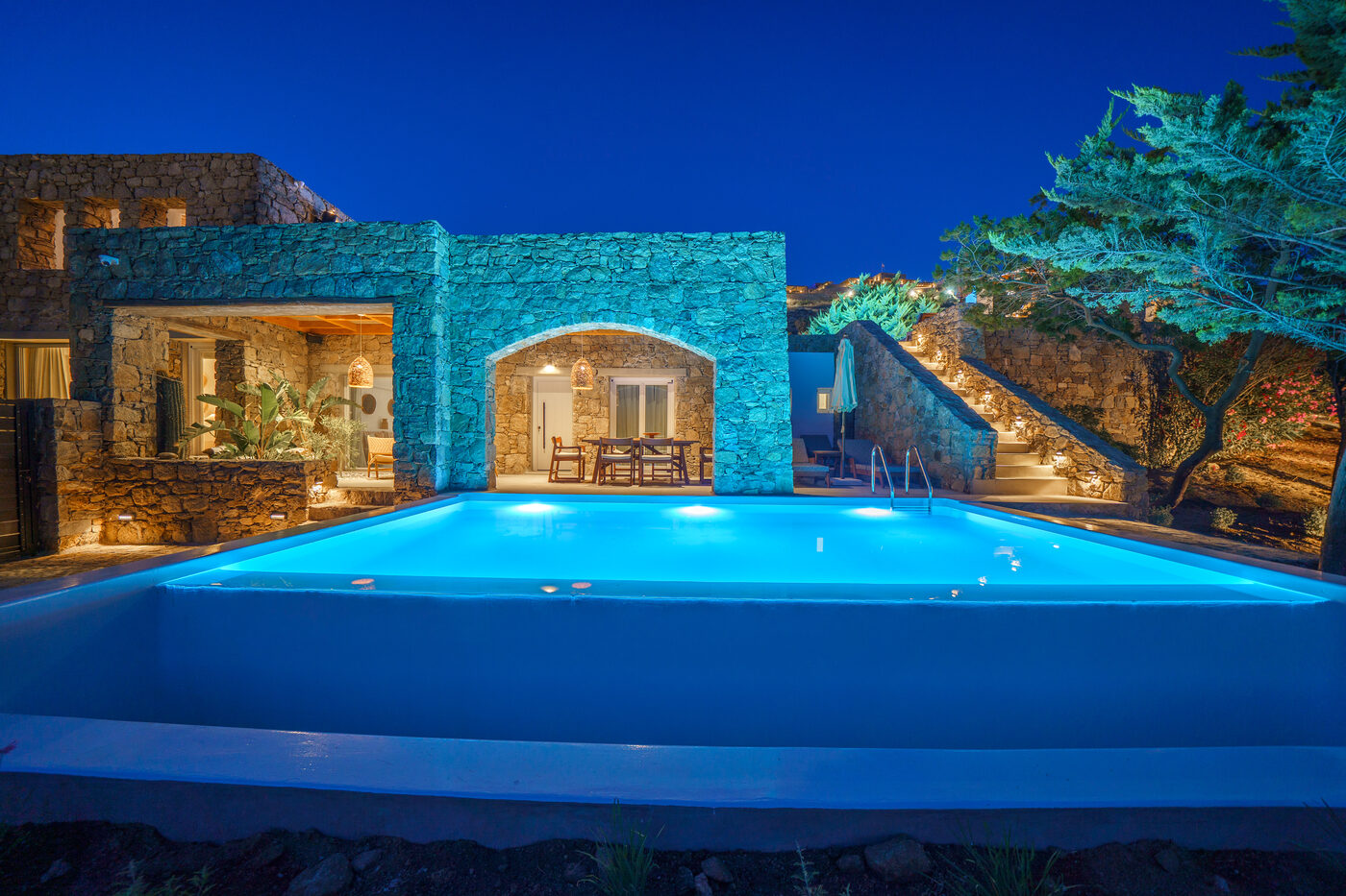 Villa Afrodite cascade pool illuminated at blue hour