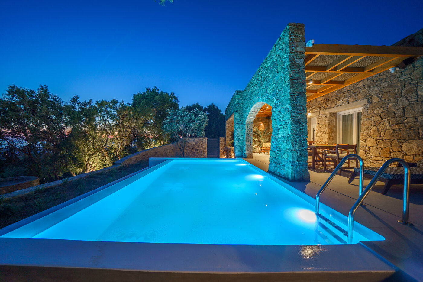 Villa Afrodite pool and sun loungers at twilight