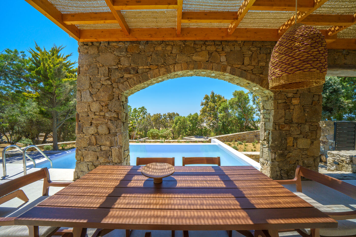 Villa Afrodite pergola-shaded dining terrace overlooking the pool