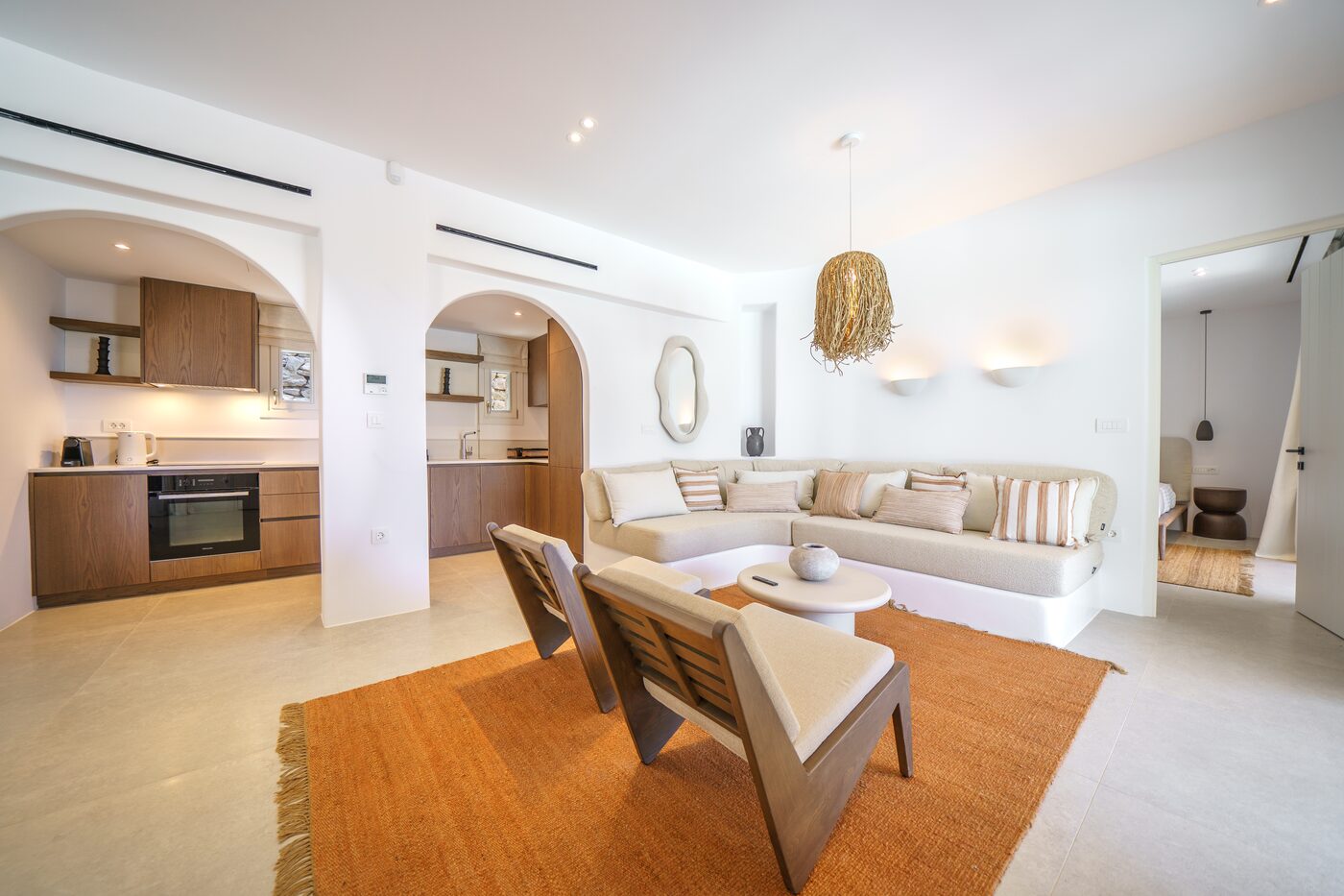 Villa Catherine living lounge with a curved sofa and open kitchen