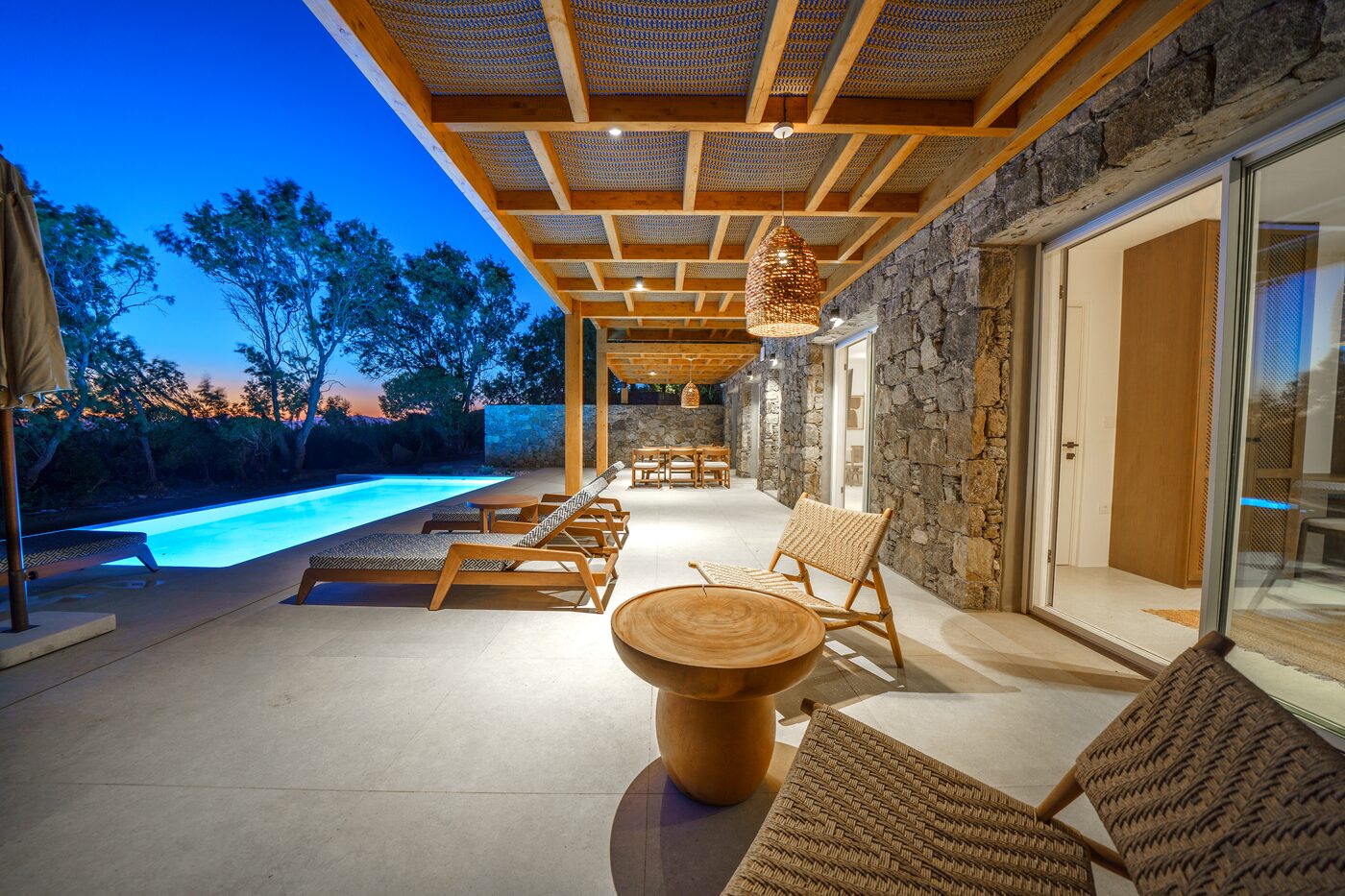 Villa Catherine pergola pool terrace with sun loungers at dusk