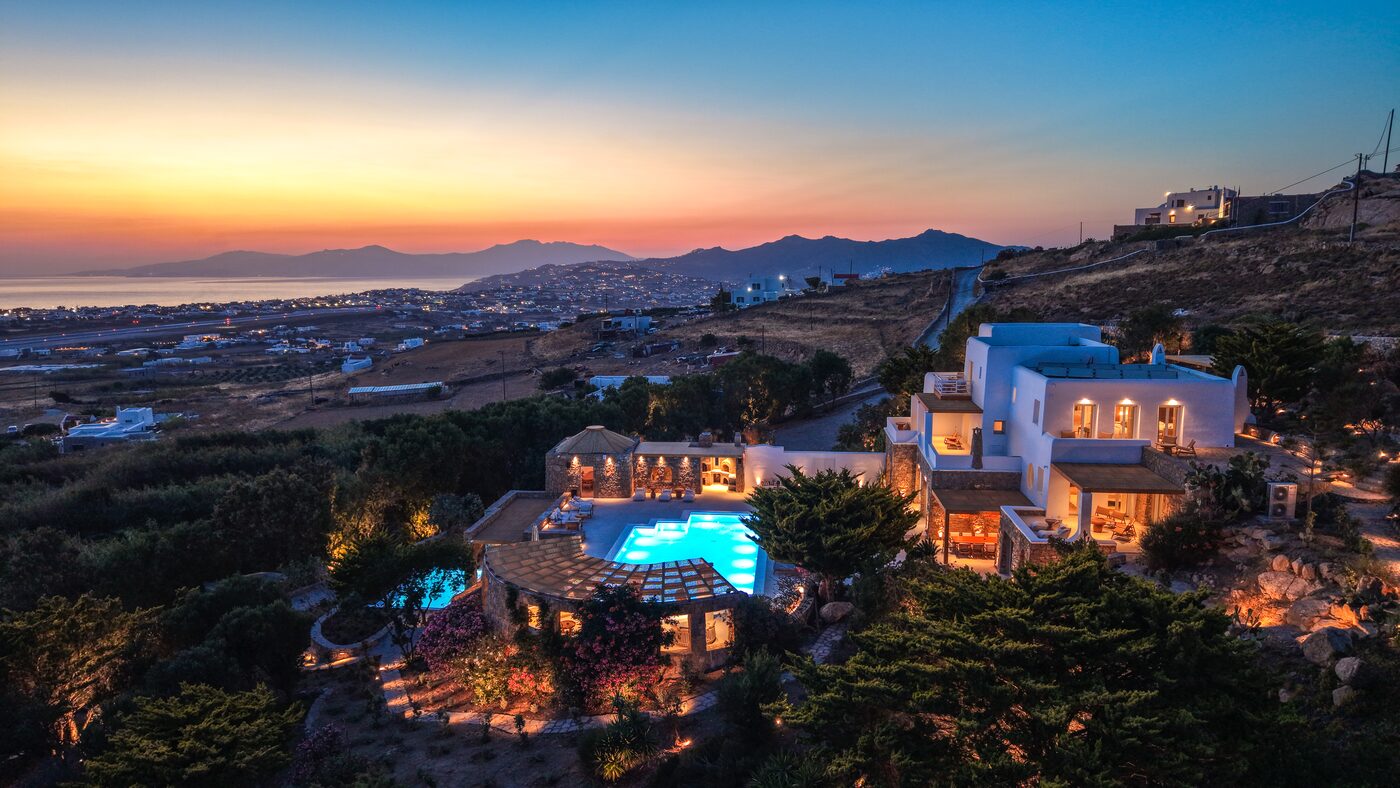 Villa Primadonna aerial view of the estate and infinity pool at dusk