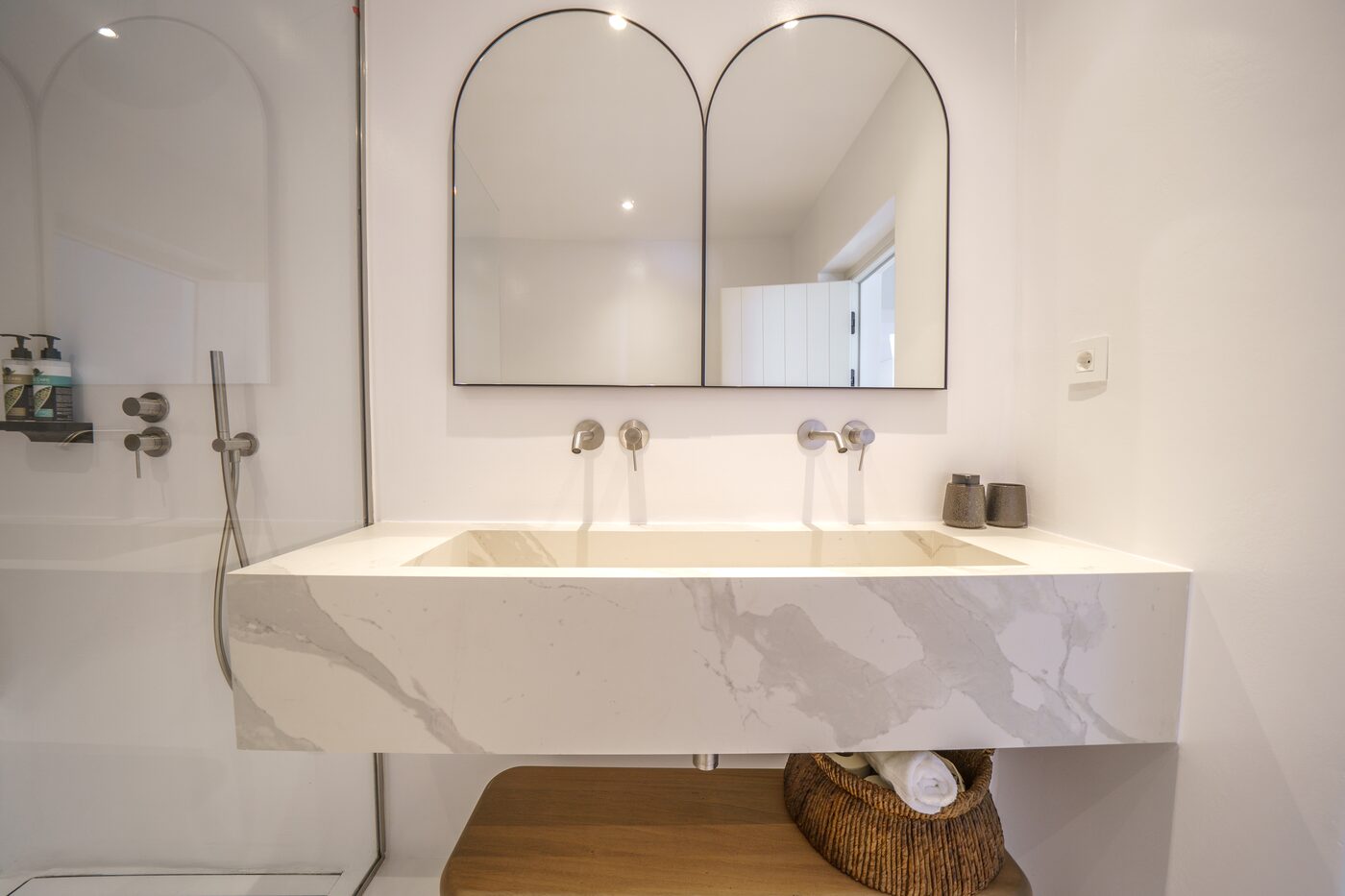 Villa Primadonna ensuite bathroom with twin arched mirrors and a travertine basin