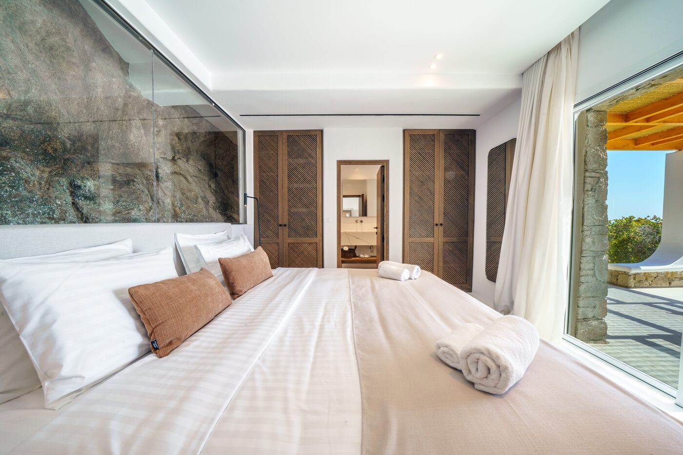 Villa Primadonna bedroom set against a natural stone wall